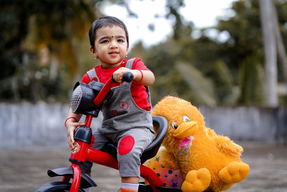 Jeune enfant assis sur son tricycle pour la première fois